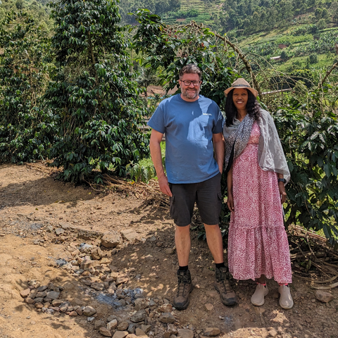 Our cofounder, Jon, and co founder of Kinini Coffee Rwanda, Jacqiue, stood in front of coffee trees at Kinini Washing Station Rwanda